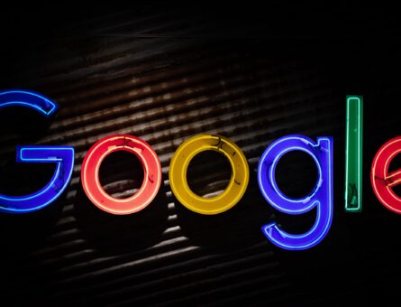 The picture used as cover for our blog post "How can Google Ads help you advance your business goals?" is Google logo highlighted with neon lamps.