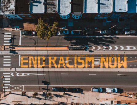 City street with "End Racism Now" signs