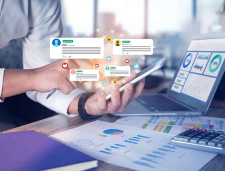 man holding phone looking table reports