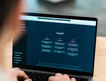 Close view of a man with opened AI chat on laptop